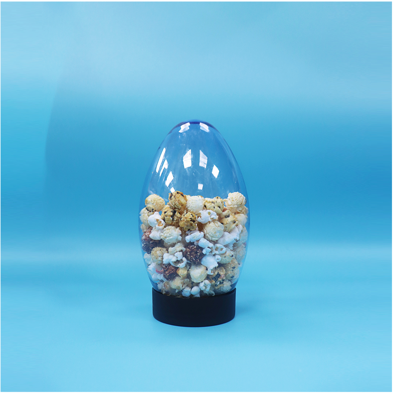 Un bocal en plastique en forme d'oeuf en forme de bonbons popcorn pistache noix bonbons à l'envers vers le bas Cap plat