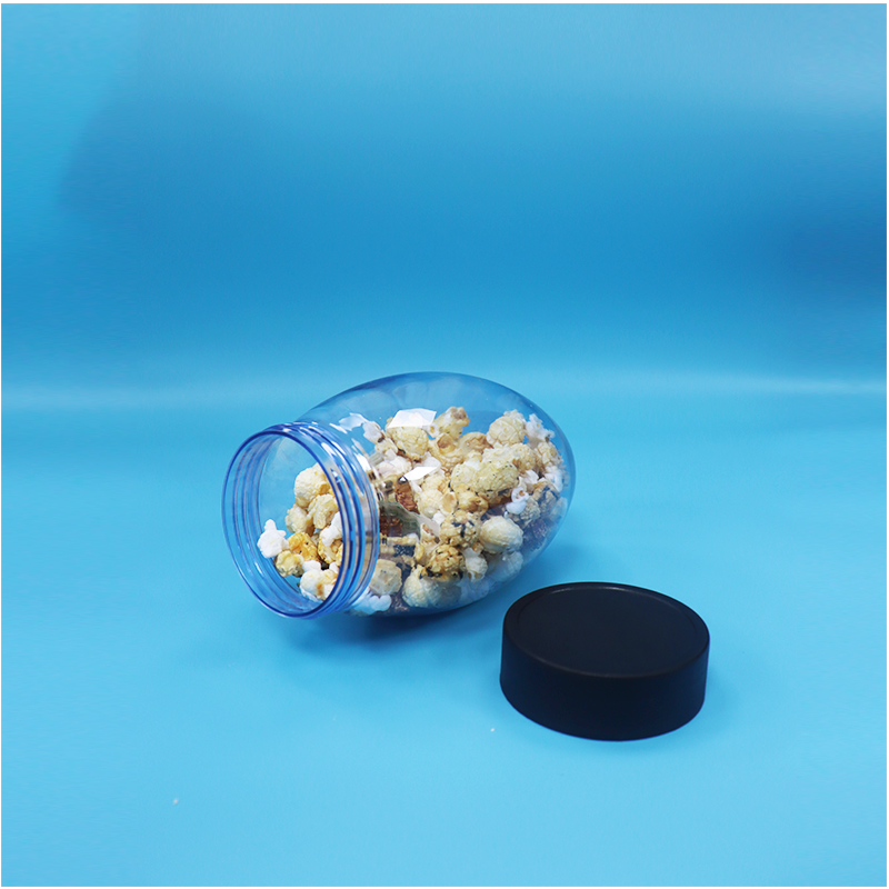 Un bocal en plastique en forme d'oeuf en forme de bonbons popcorn pistache noix bonbons à l'envers vers le bas Cap plat