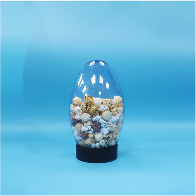 Un bocal en plastique en forme d'oeuf en forme de bonbons popcorn pistache noix bonbons à l'envers vers le bas Cap plat
